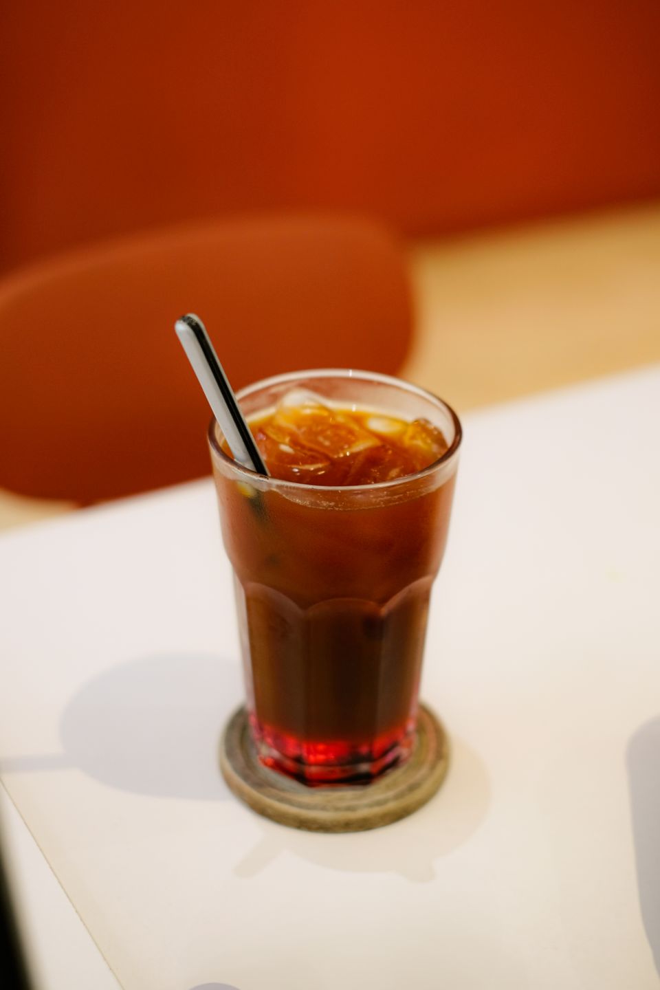 Illustrative photo of amber iced tea with visible ice cubes in a tall glass.