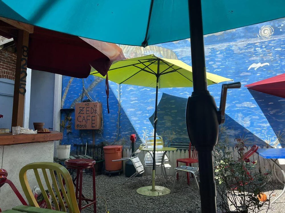 Umbrellas above the tables on the patio at Zed’s Cafe.